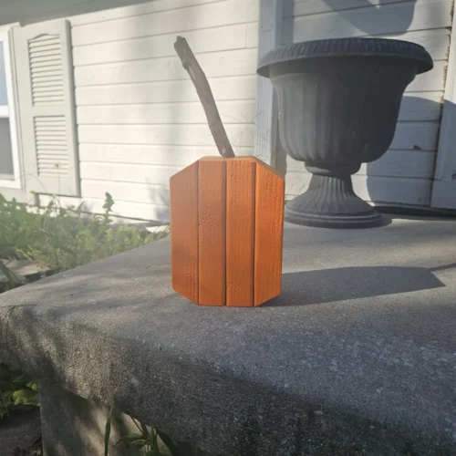 Small Orange Jack-O-Lantern made from 2x4 and a natural branch as stem.